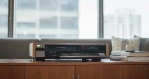 Can You Still Buy a VCR? Can you still buy a VCR? A JVC VHS video cassette recorder on a media cabinet in a modern living room.