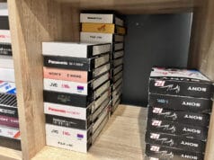 How long do VHS tapes last? A shelf of VHS tapes kept in a home office, the kind of everyday storage that decides how long do VHS tapes last.