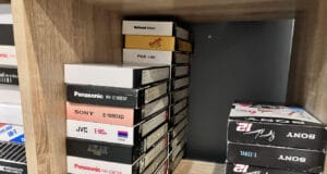 How long do VHS tapes last? A shelf of VHS tapes kept in a home office, the kind of everyday storage that decides how long do VHS tapes last.