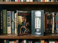 VHS vs DVD VHS vs DVD: a DVD case beside a home-recorded VHS tape on a bookshelf.